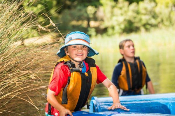 Smiling child walking out from the water of Cave Hill Creek