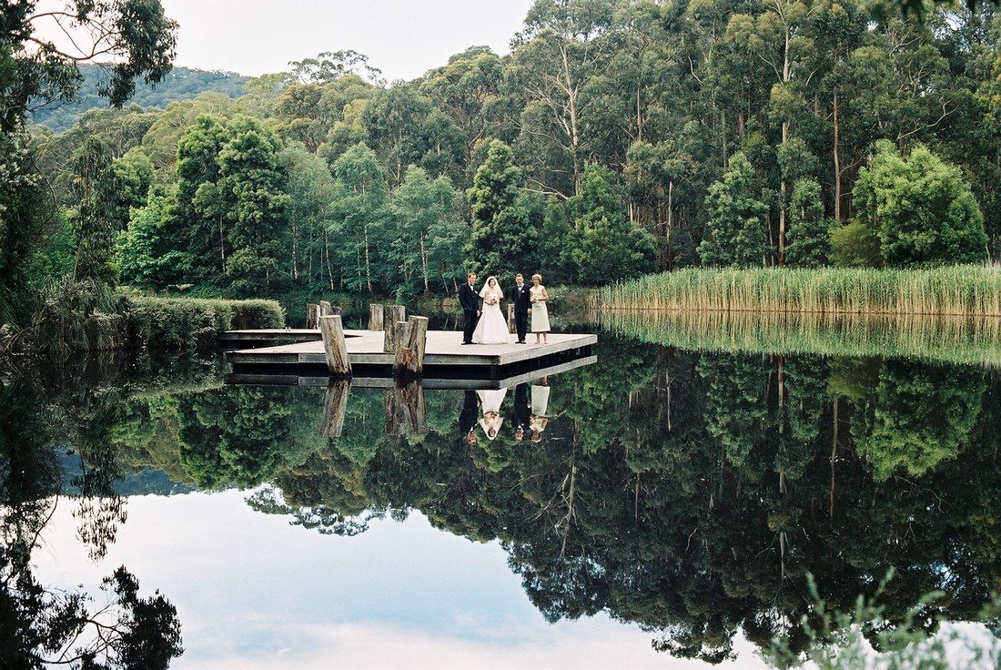 Wedding couple standing at Cave Hill Creek waterfront