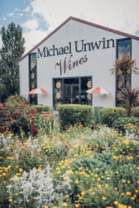 Image of front of Michael Unwin Wines building during spring time with florals in the forefront
