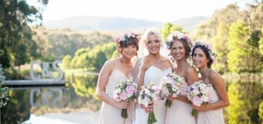 group photo of bride and bridesmaids with cave hill creek and hills in background