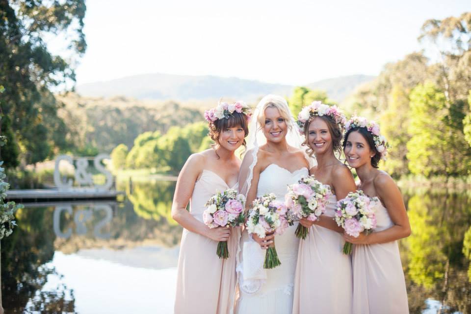 group photo of bride and bridesmaids with cave hill creek and hills in background
