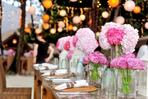 Close up image of pink floral arrangements on tables at a wedding