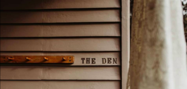 Close up image of The Den building signage