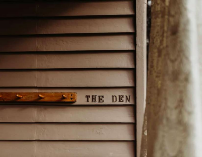 Close up image of The Den building signage