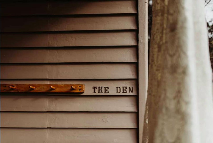 Close up image of The Den building signage