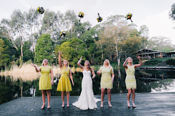 bride and bridesmaids throwing bouquets