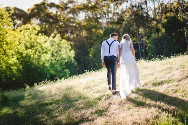 bride and groom walking in nature
