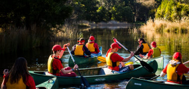 Kids in canoes on lake